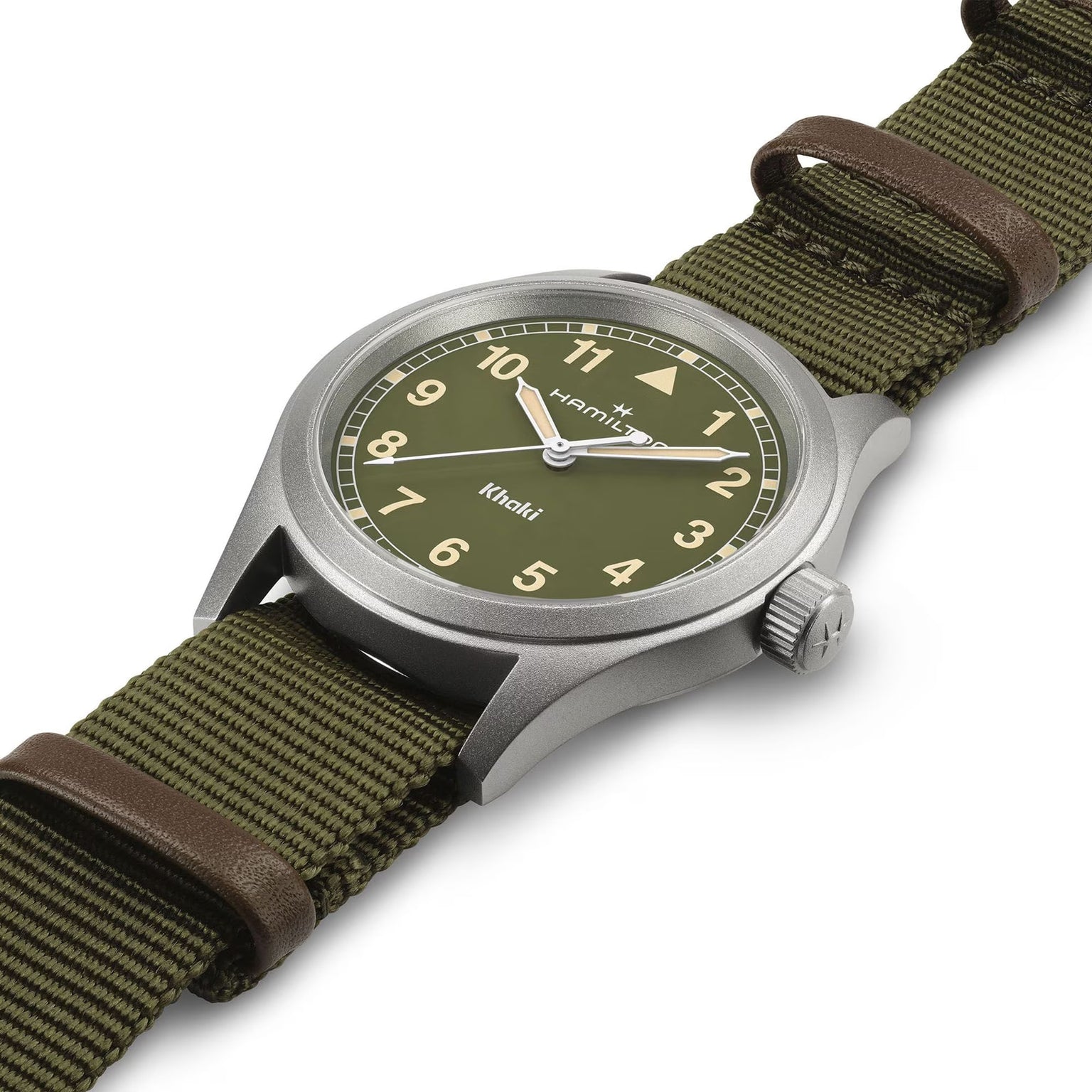 The Hamilton Khaki Field Quartz 38mm watch features a green dial, fabric strap, and silver case, displayed at an angle on a white background.