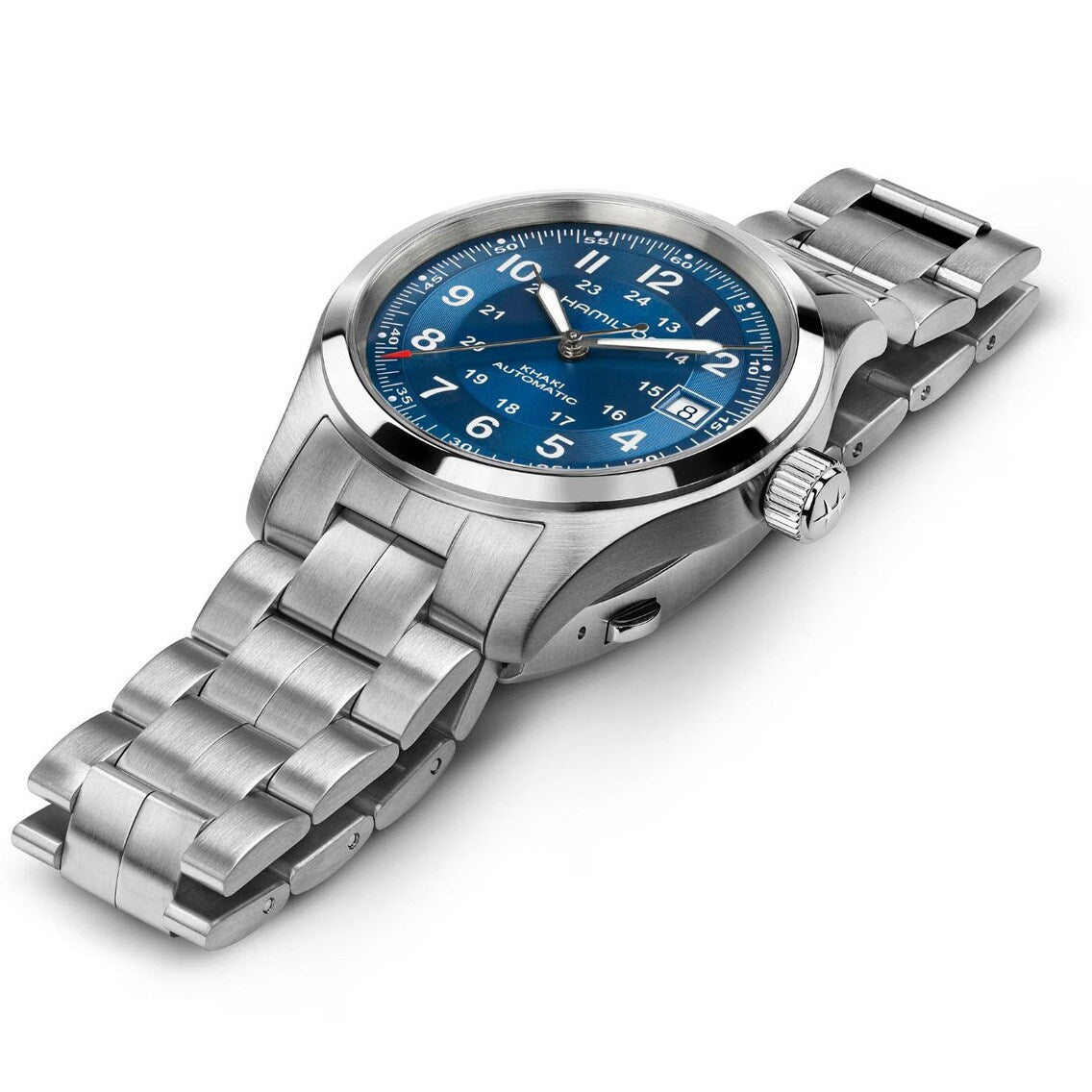 The Hamilton Khaki Field Auto 38mm features a stainless steel case, blue dial with white numerals, and a metal link band, shown at an angle.
