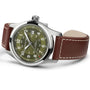 The Hamilton Khaki Field Auto 42mm features an olive green dial, a brown leather strap, and a silver case, captured from an angled perspective.