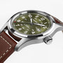 Close-up of the Hamilton Khaki Field Auto 42mm wristwatch featuring an olive green dial and a brown leather strap.