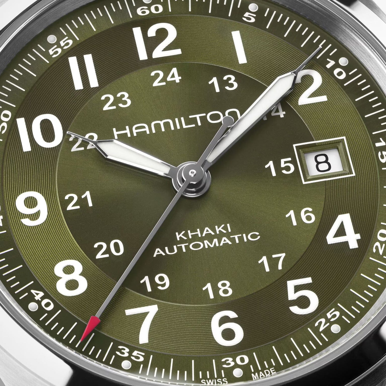 Close-up of a green Hamilton Khaki Field Auto 42mm watch displaying the date as the 8th.