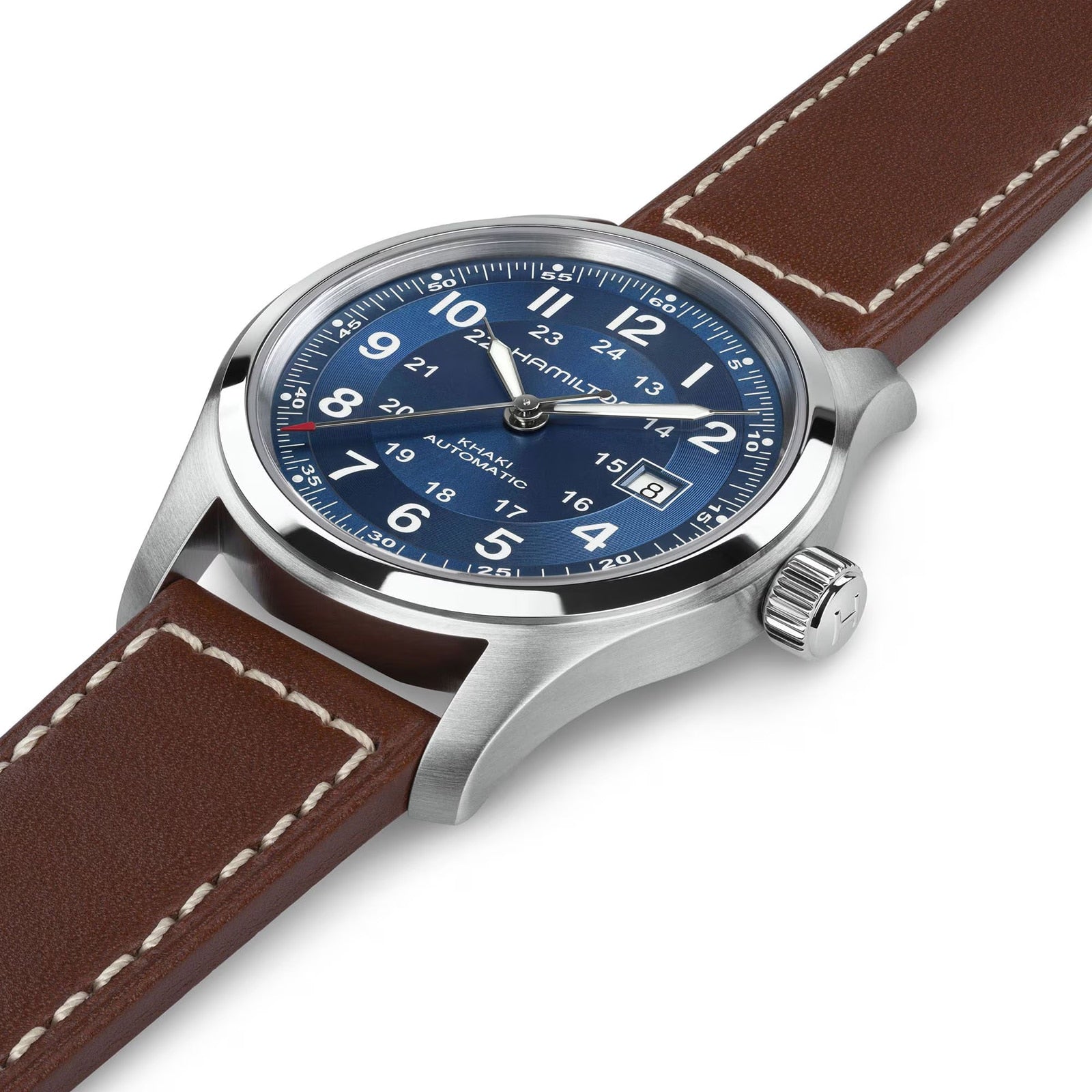 The Hamilton Khaki Field Auto 42mm features a silver case, blue dial, and brown leather strap with white stitching, shown at an angle.