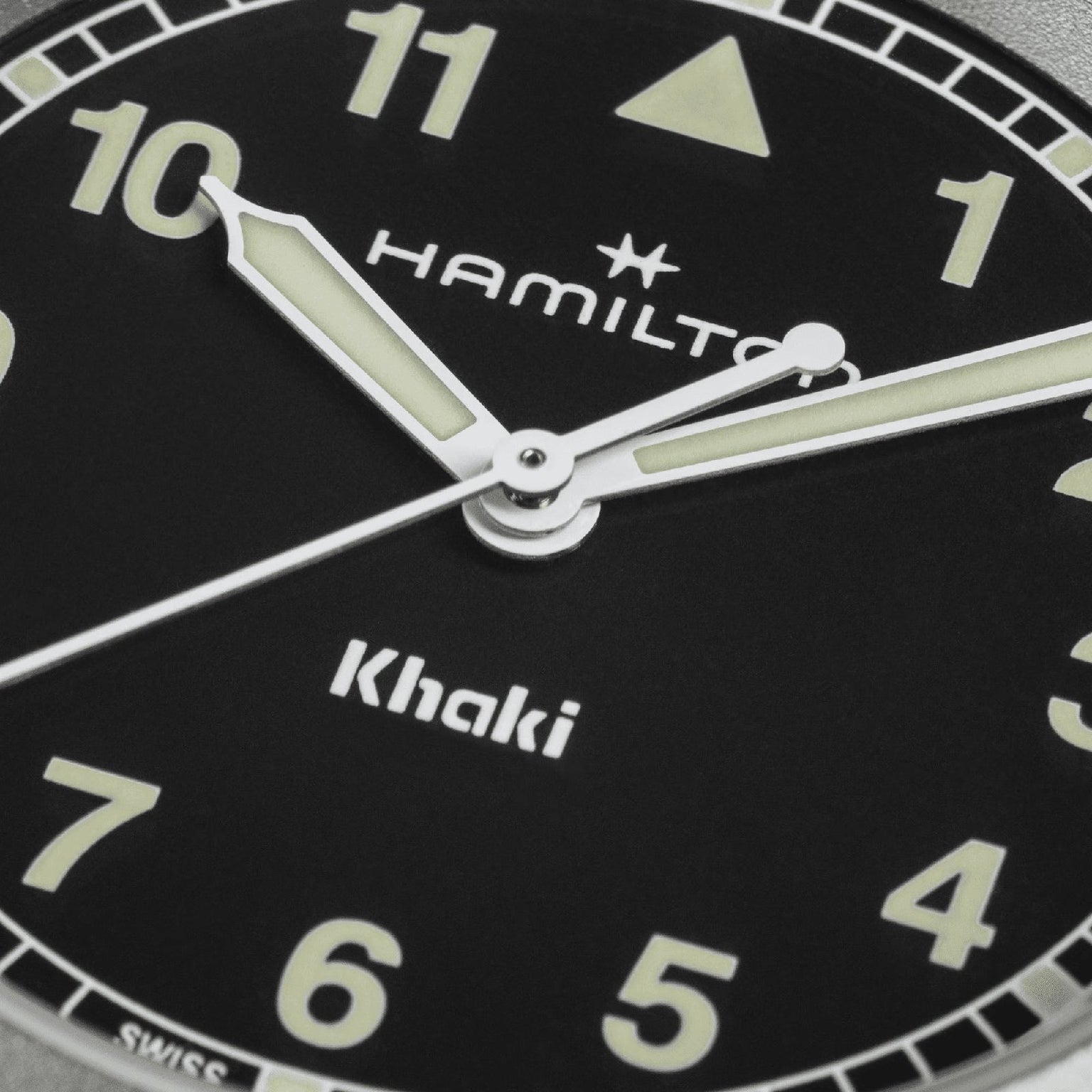Close-up of the Hamilton Khaki Field Quartz 33mm, featuring luminous hands and bold Arabic numerals on a black dial—built for adventure. Time displayed: 10:08:37.
