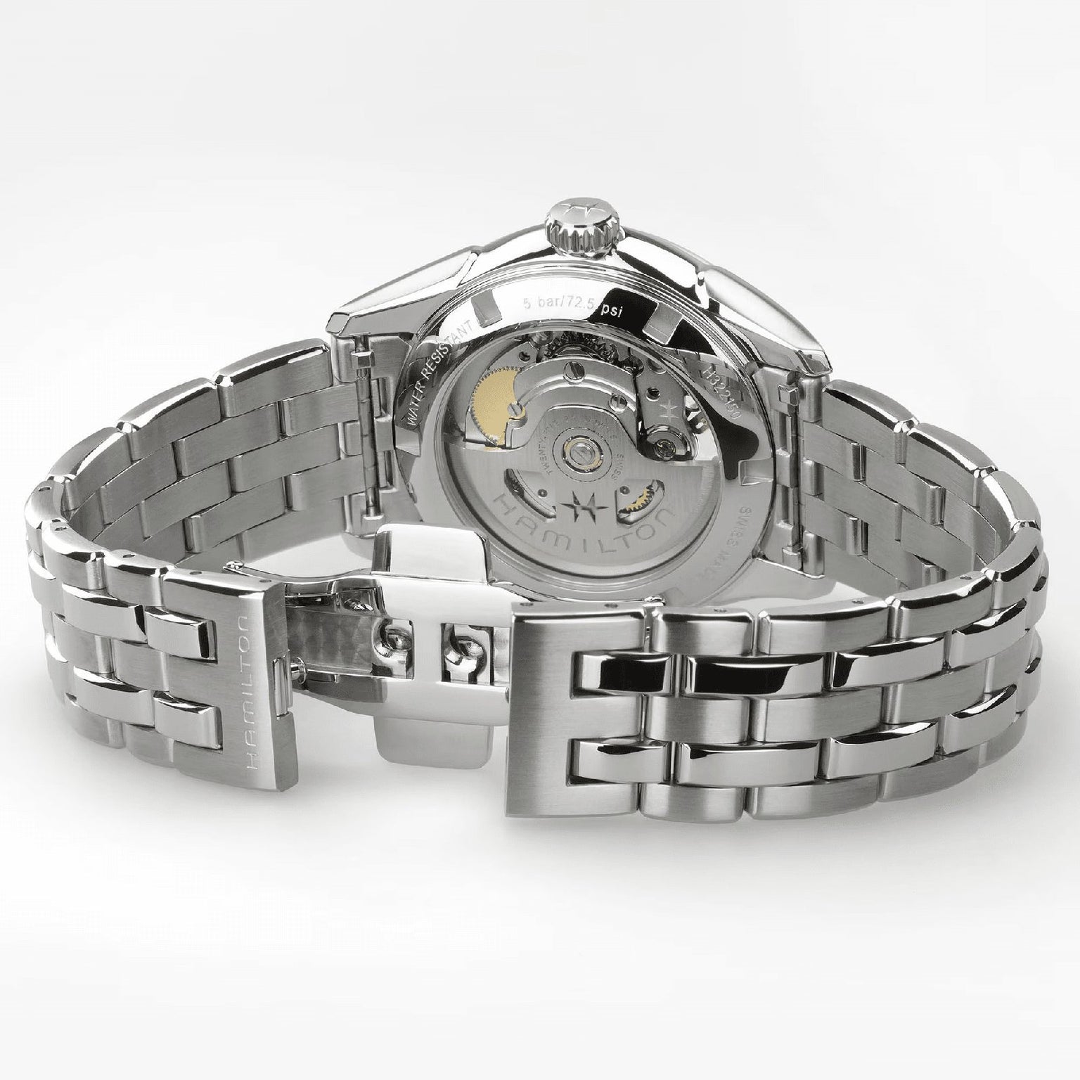 A close-up of the Hamilton Jazzmaster Open Heart Lady Auto wristwatch, featuring a stainless steel bracelet, open clasp, and a transparent case back that reveals its automatic movement.