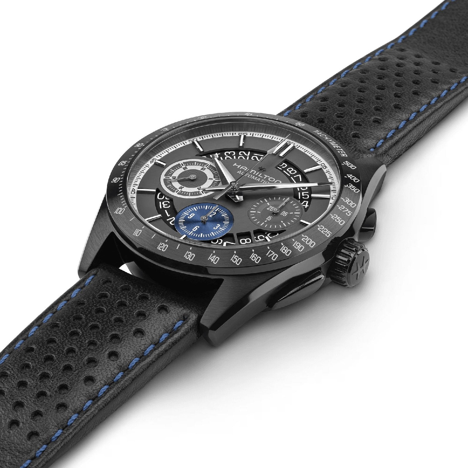 The Hamilton Jazzmaster Performer Autochrono 42mm features a black case, perforated leather strap with blue stitching, and three chronograph counters—one in striking blue—shown against a white background.