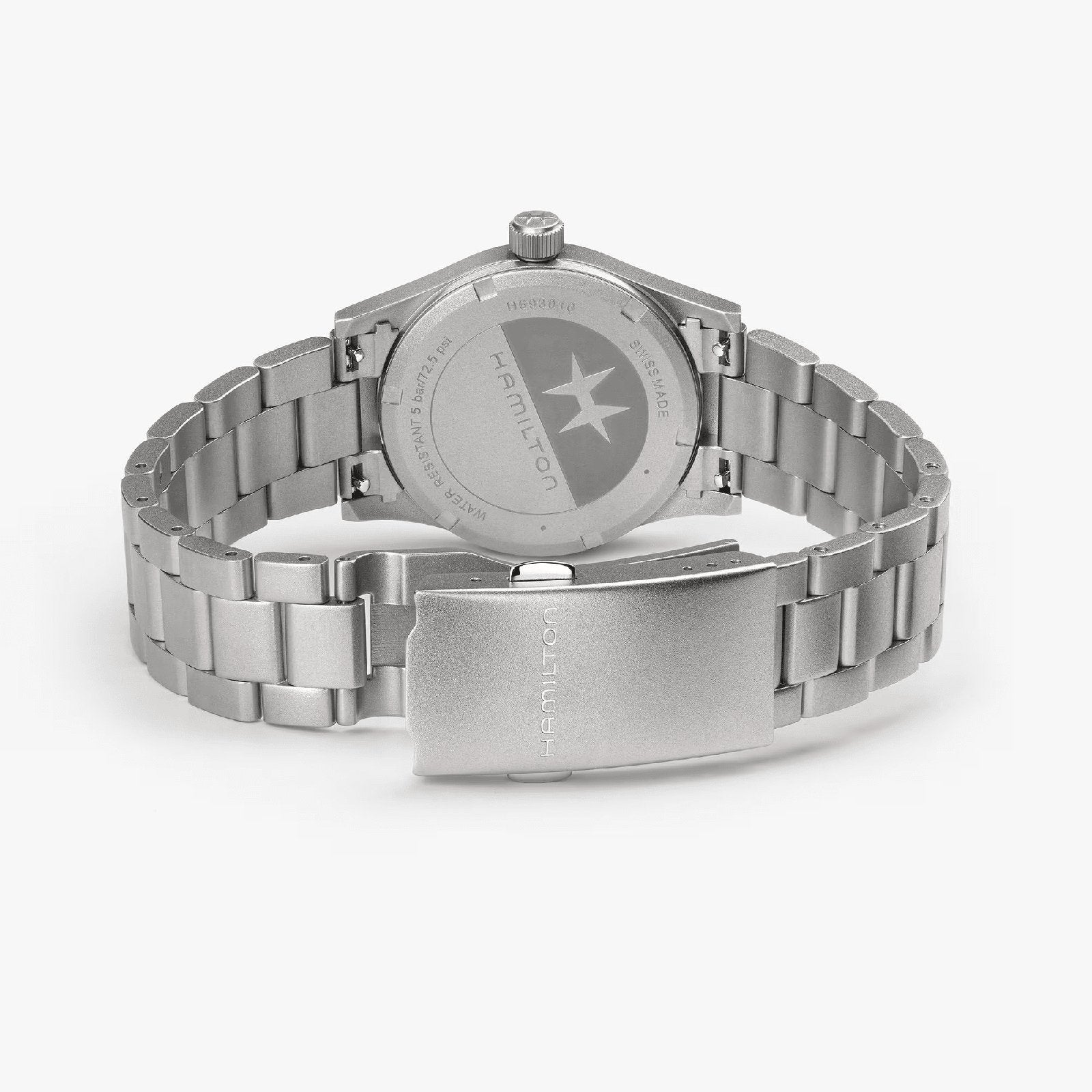 The Hamilton Khaki Field Quartz 33mm wristwatch is shown from the back, highlighting its stainless steel clasp, bracelet links, and engraved case back—an exploration-ready and durable timepiece.