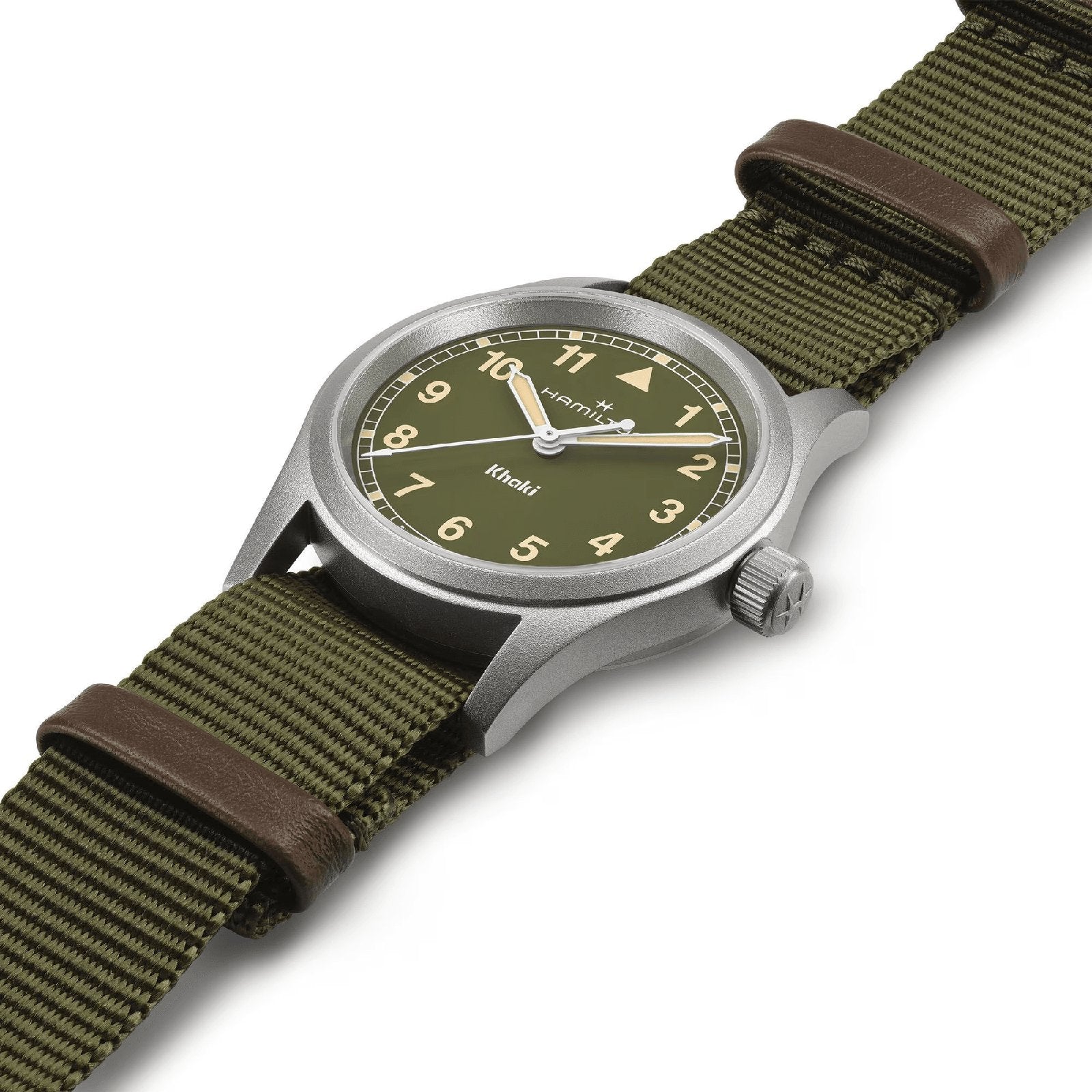 The Hamilton Khaki Field Quartz 33mm boasts a durable design with an olive dial, khaki fabric strap, Arabic numerals, and a silver case, all reflecting classic military heritage and set against a white background.