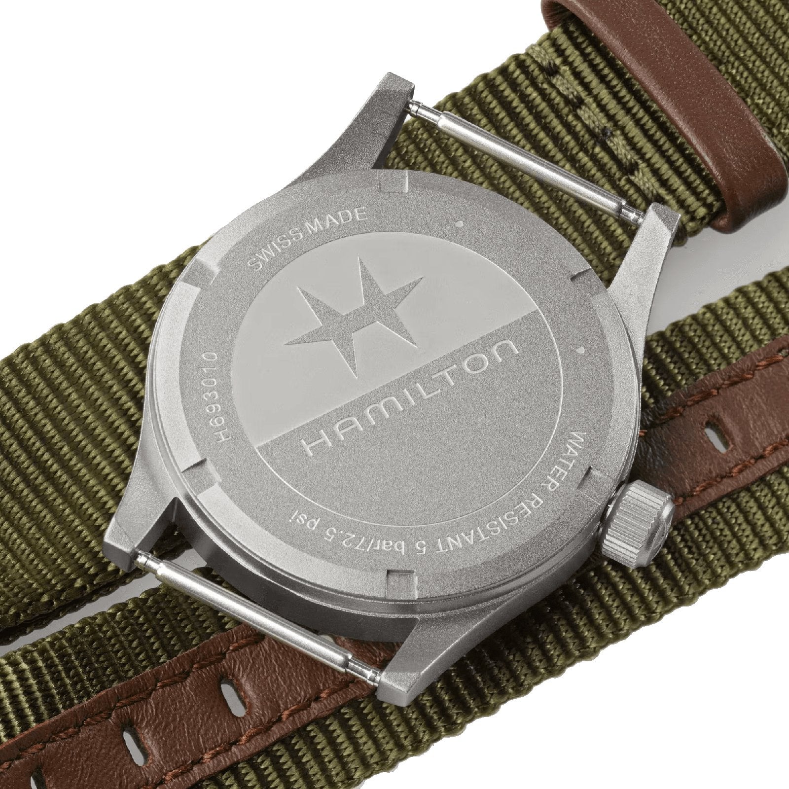 The back of the Hamilton Khaki Field Quartz 33mm features engraved branding, a star symbol, and a NATO-style green strap with brown leather accents, underscoring its military heritage and durable design.