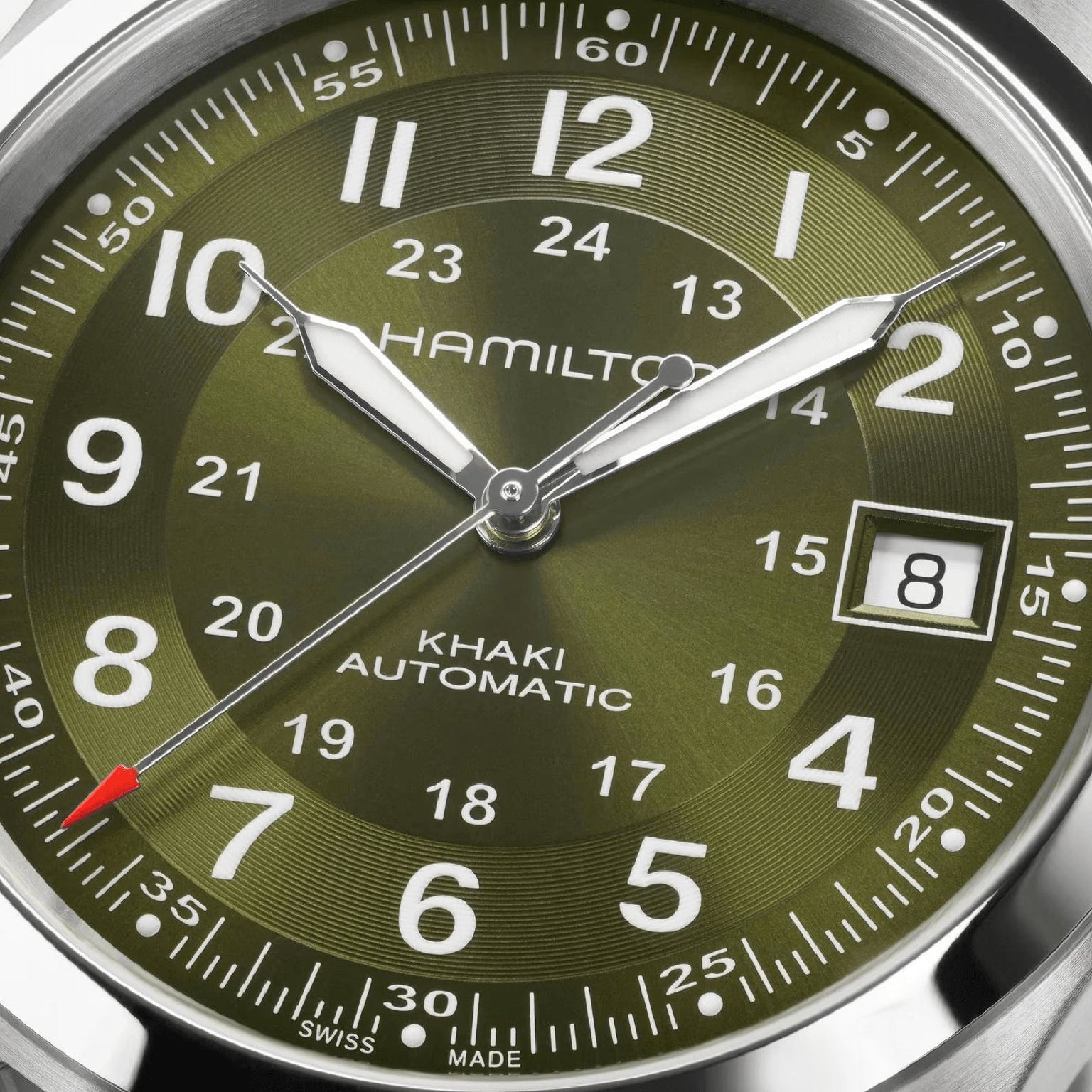 Close-up of the Hamilton Khaki Field Auto 38mm watch in green, displaying 8:07:36 with a date window at 8—showcasing its automatic movement and iconic military-inspired design.