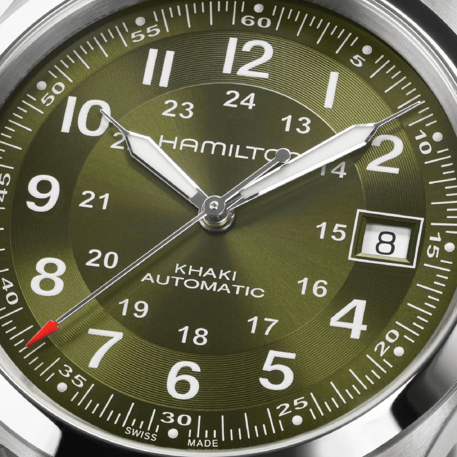 Close-up of the Hamilton Khaki Field Auto 38mm watch in green, displaying 8:07:36 with a date window at 8—showcasing its automatic movement and iconic military-inspired design.