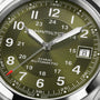 Close-up of the Hamilton Khaki Field Auto 38mm watch in green, displaying 8:07:36 with a date window at 8—showcasing its automatic movement and iconic military-inspired design.