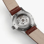 Back view of the Hamilton Khaki Field Auto 38mm shows its automatic movement and transparent case back, brown leather strap, and engraved branding—highlighting the military-inspired design.