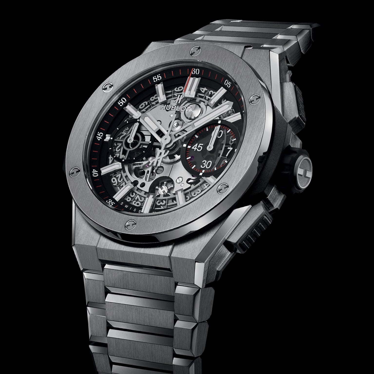 The Hublot Big Bang Integrated Titanium is a luxury wristwatch with a titanium case, skeleton dial showcasing visible gears, and a metal bracelet—photographed against black for a striking effect and refined taste.