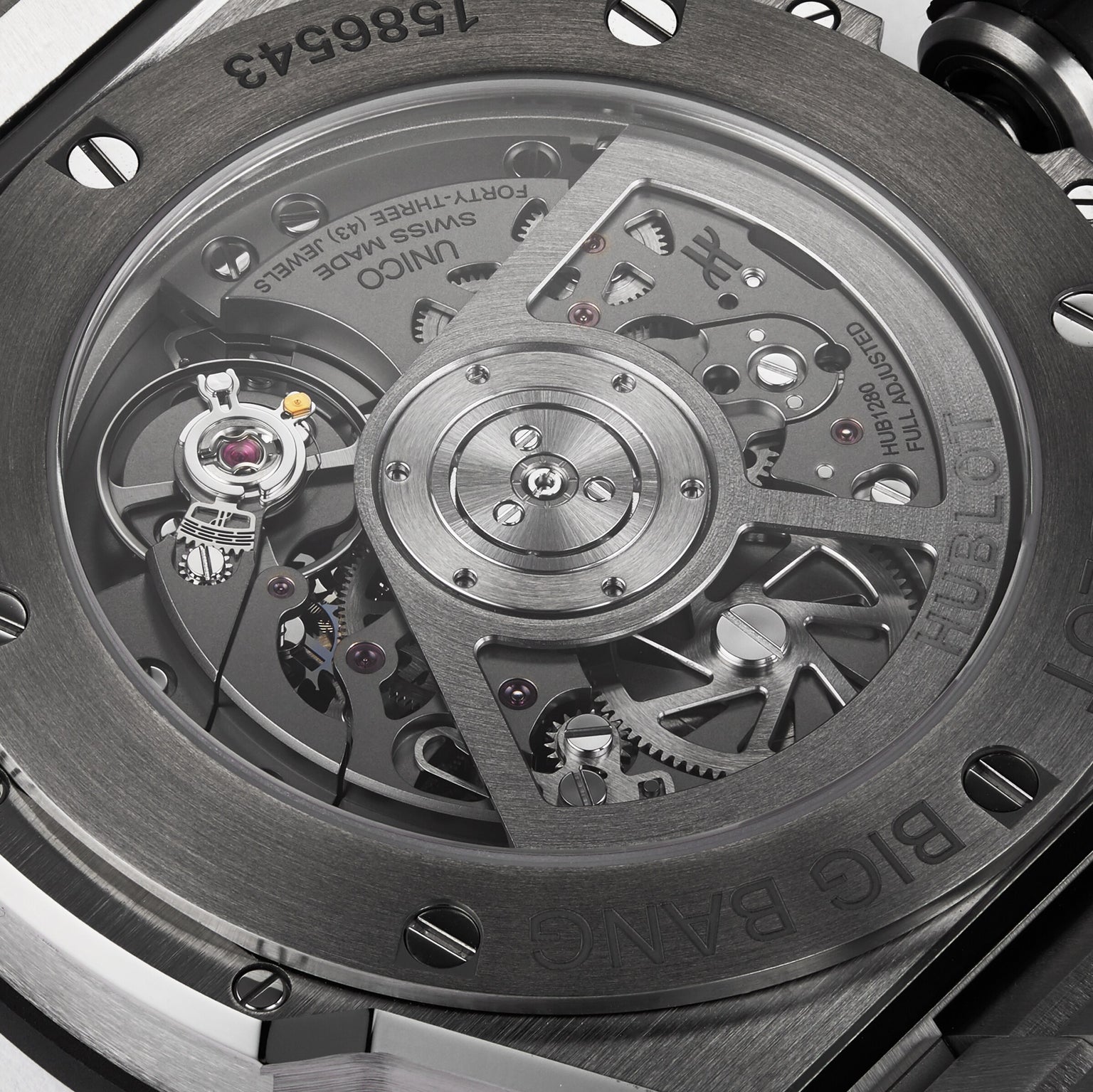 Close-up of the transparent caseback of the Hublot Big Bang Integrated Titanium, showing the detailed mechanical movement and internal gears within its titanium case and advanced self-winding chronograph.