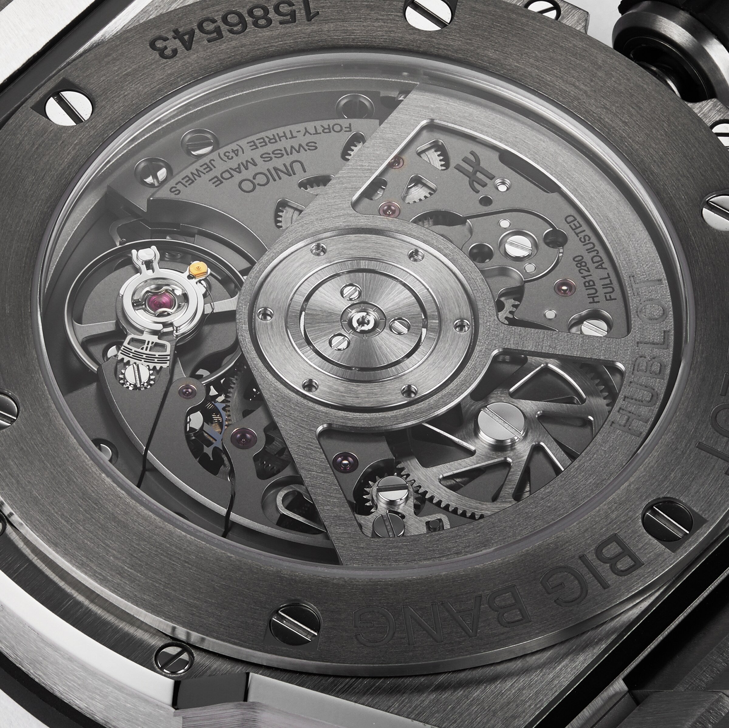 Close-up of the transparent caseback of the Hublot Big Bang Integrated Titanium, showing the detailed mechanical movement and internal gears within its titanium case and advanced self-winding chronograph.