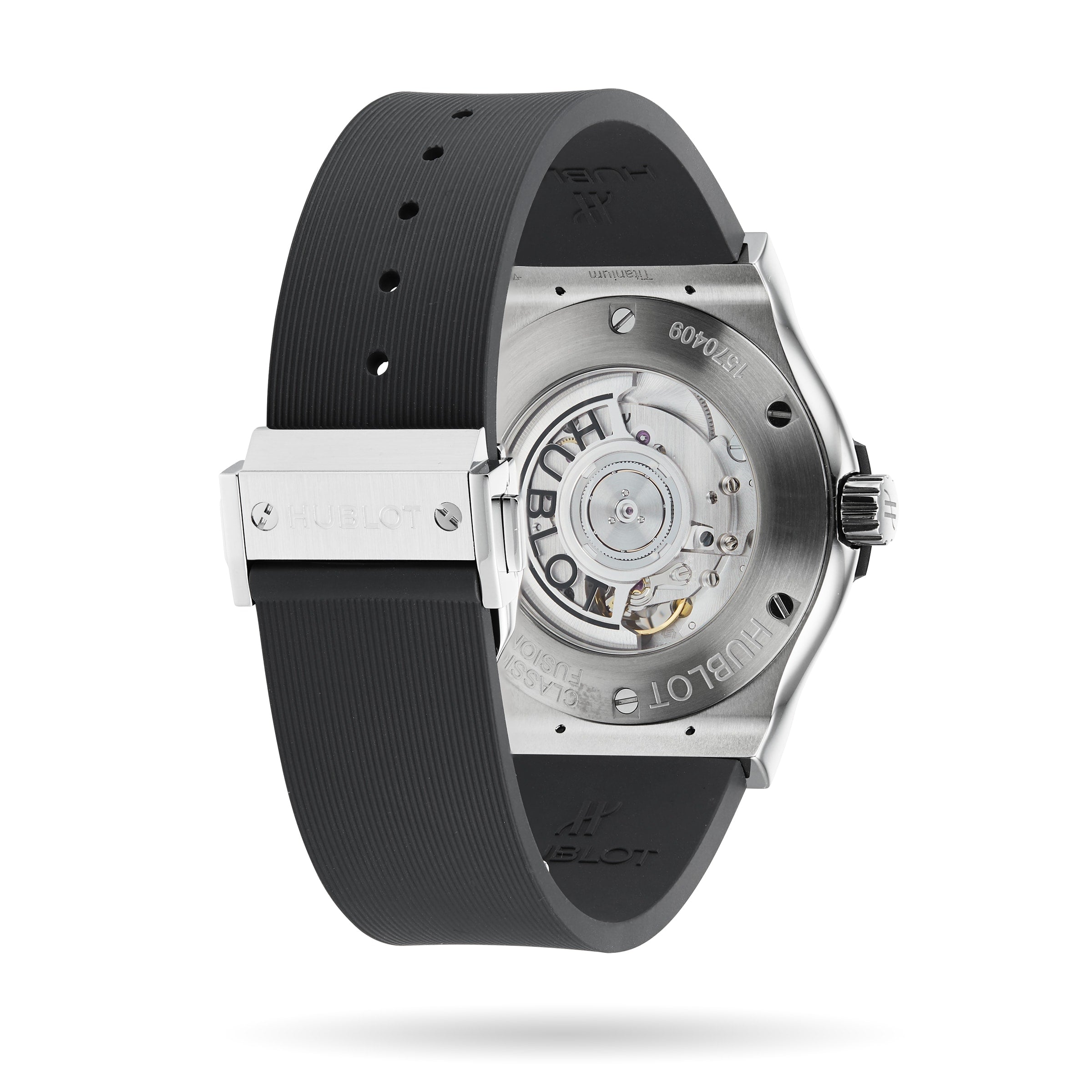 The image shows the back of a Hublot Classic Fusion Racing Grey Titanium watch, featuring a see-through case back that reveals the mechanical movement, with a titanium case and black rubber strap.