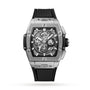 The Hublot Spirit of Big Bang Titanium is a luxury rectangular silver watch with a titanium case, skeleton dial, chronograph features, black screws, and a black ribbed rubber strap, shown against a white background.