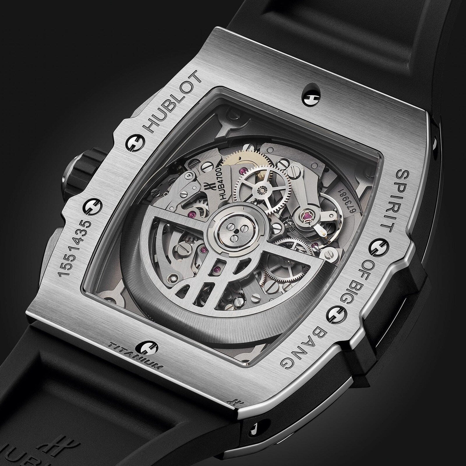 Close-up view of the back of the Hublot Spirit of Big Bang Titanium, highlighting its exposed mechanical movement, titanium case with engraved labeling, and a black rubber strap.