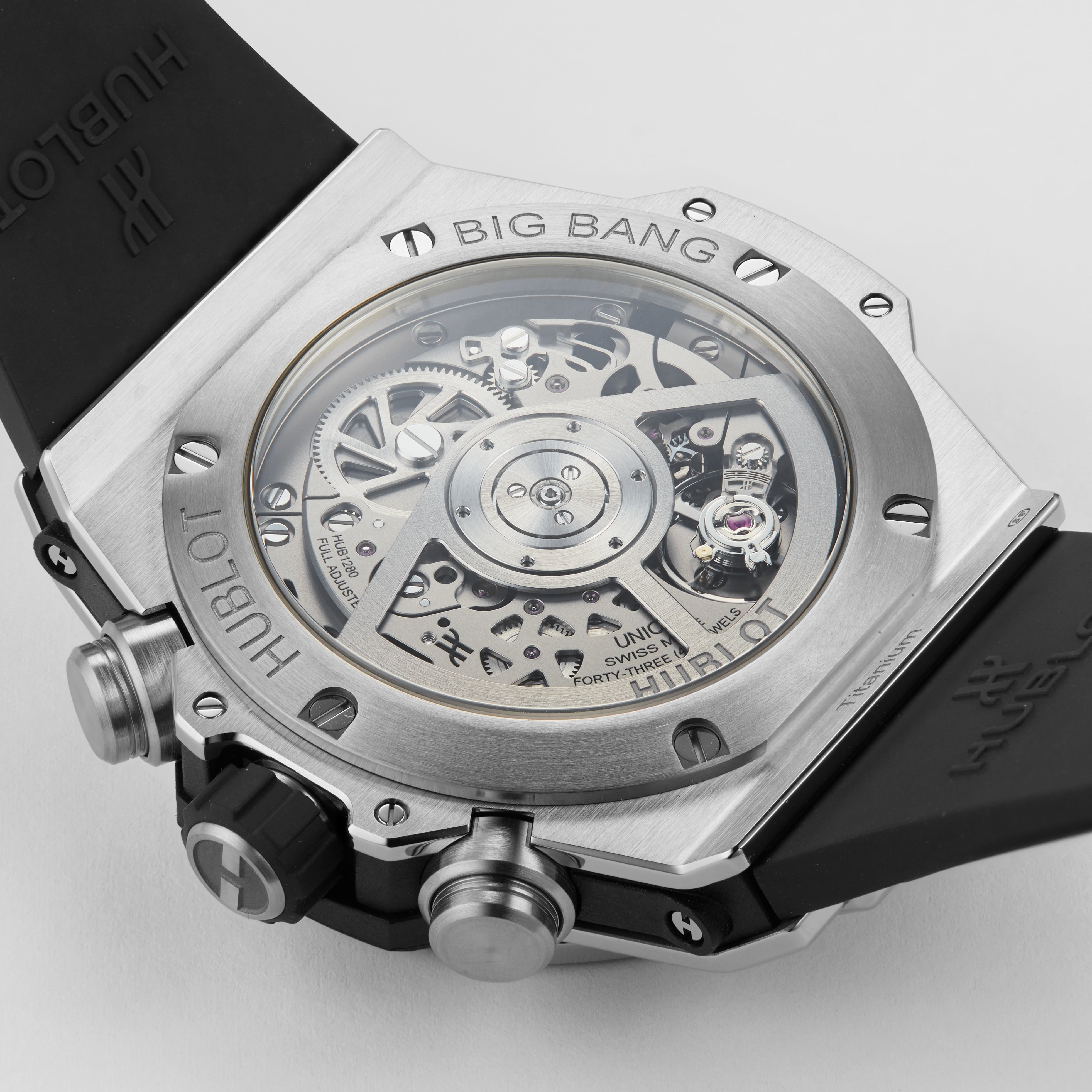 Close-up of the back of the Hublot Big Bang Unico Titanium, highlighting its exposed UNICO manufacture chronograph flyback movement and black rubber strap.