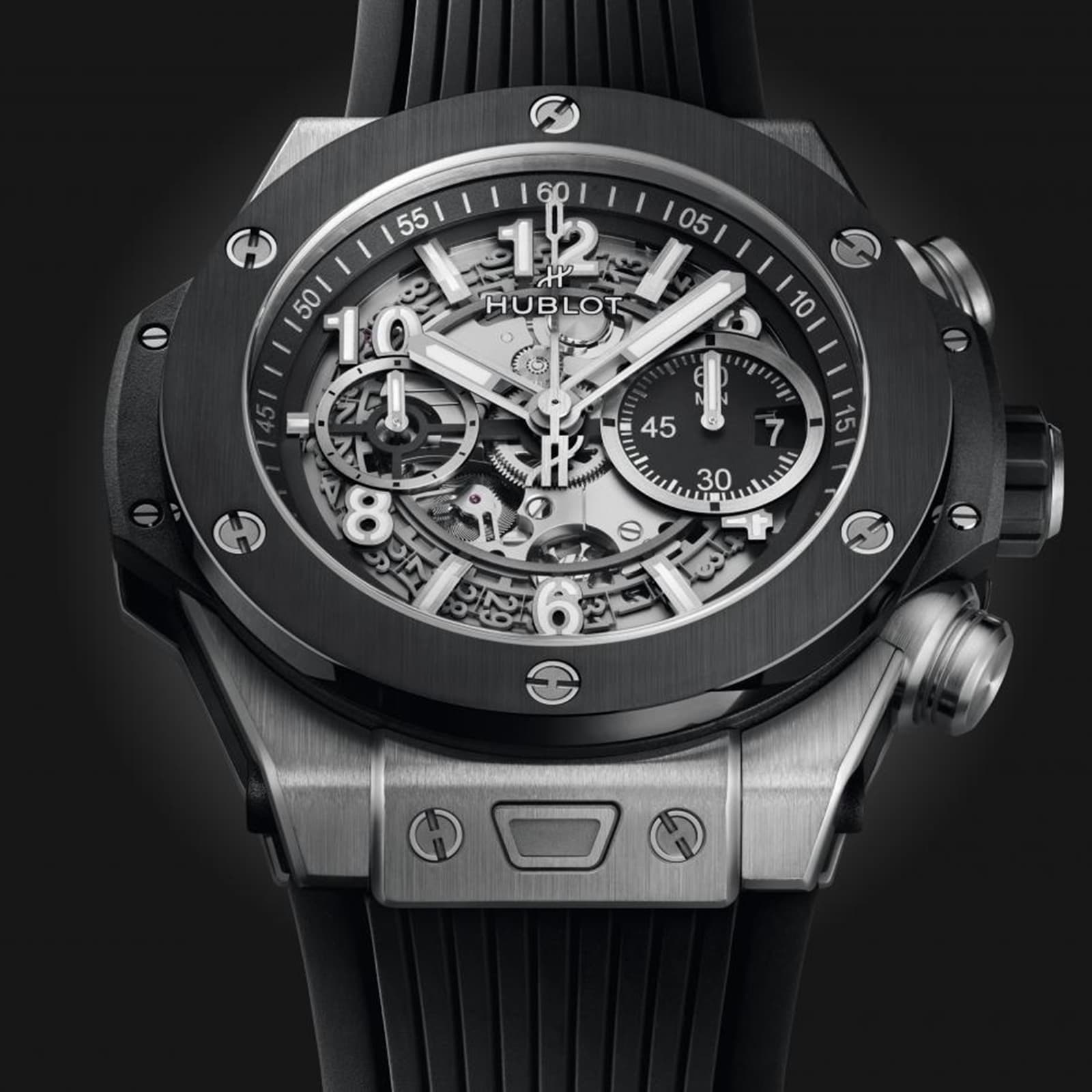 Close-up of a Hublot Big Bang Unico Titanium Ceramic wristwatch featuring a skeleton dial with visible gears, chronograph subdials, and a black rubber strap.