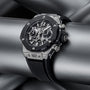 The Hublot Big Bang Unico Titanium Ceramic wristwatch, featuring a silver and black skeleton dial with a rubber strap, is showcased on metallic pipes, emphasizing the collection’s bold and modern design.