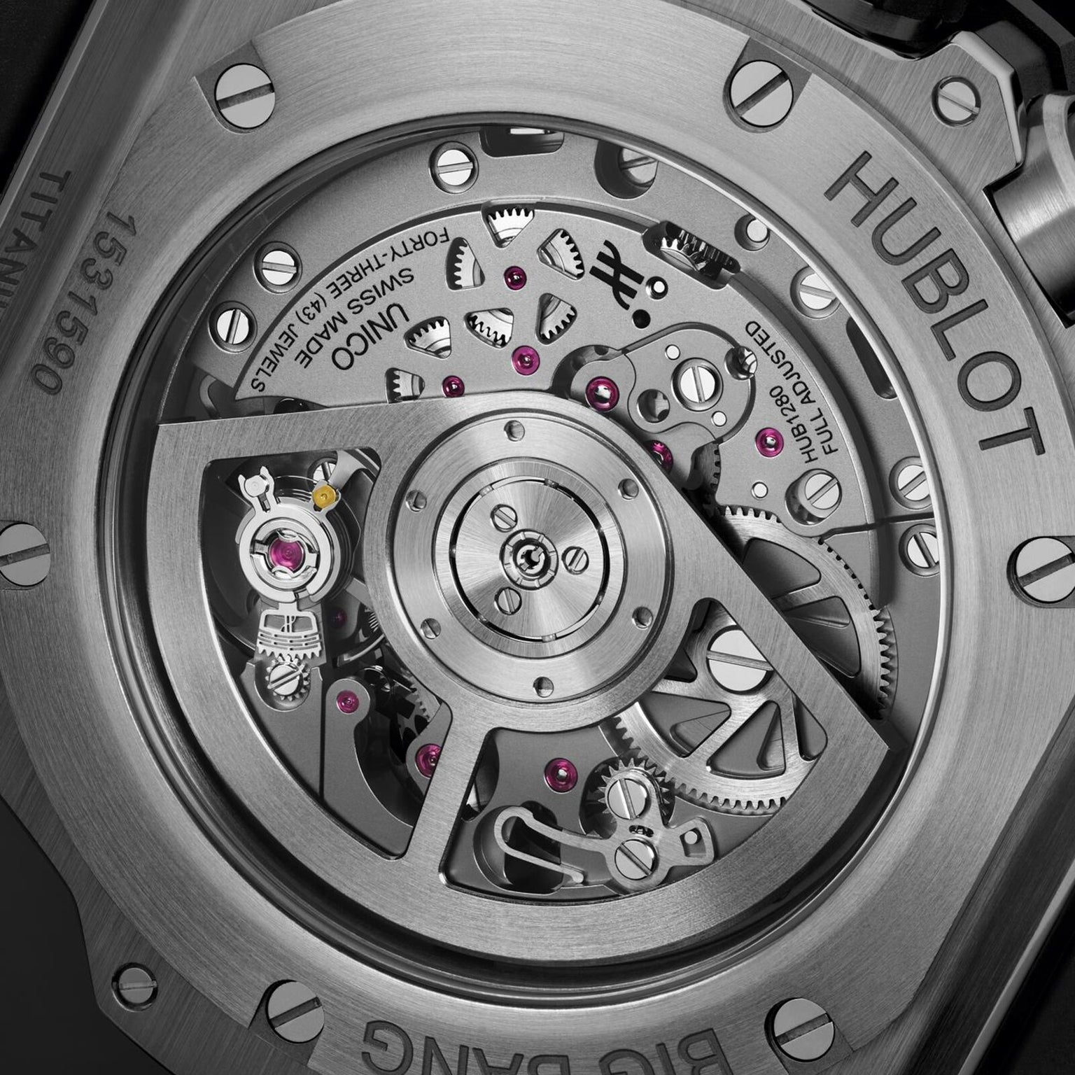 Close-up view of the back of the Hublot Big Bang Unico Titanium Ceramic, highlighting its intricate Unico Manufacture mechanical movement and engraved markings on the titanium case.