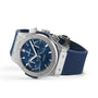The Hublot Classic Fusion Chronograph Titanium Blue wristwatch, with a blue dial and blue rubber strap, is shown at an angle on a white background.