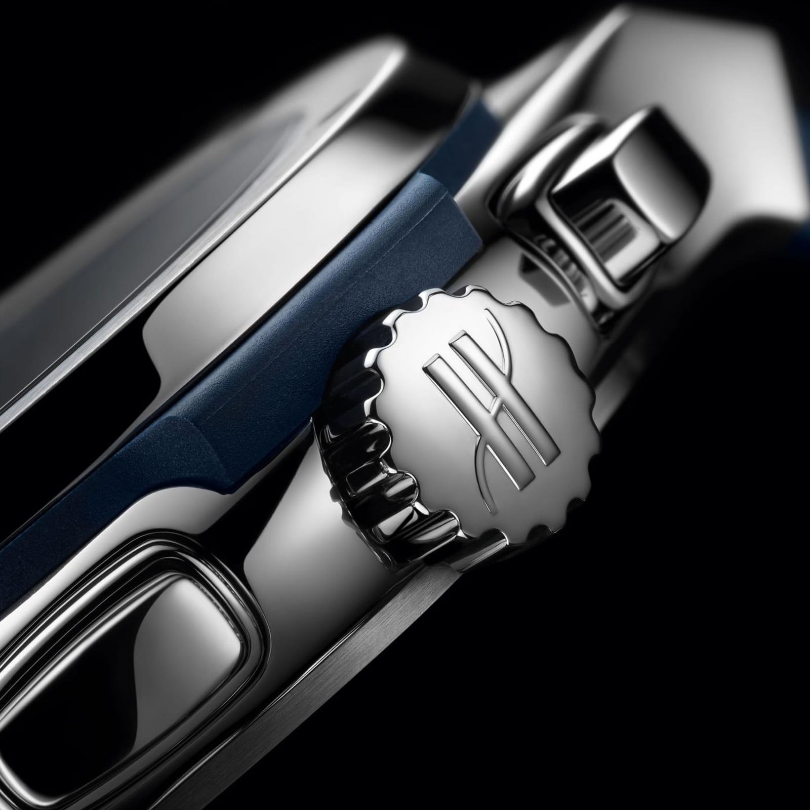 Close-up of the engraved crown and side buttons on the Hublot Classic Fusion Chronograph Titanium Blue, set in a sleek titanium case.