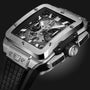 A close-up of the Hublot Square Bang Unico Titanium, showcasing its rectangular titanium case, black rubber strap, and skeleton dial that reveals the detailed Unico movement inside.
