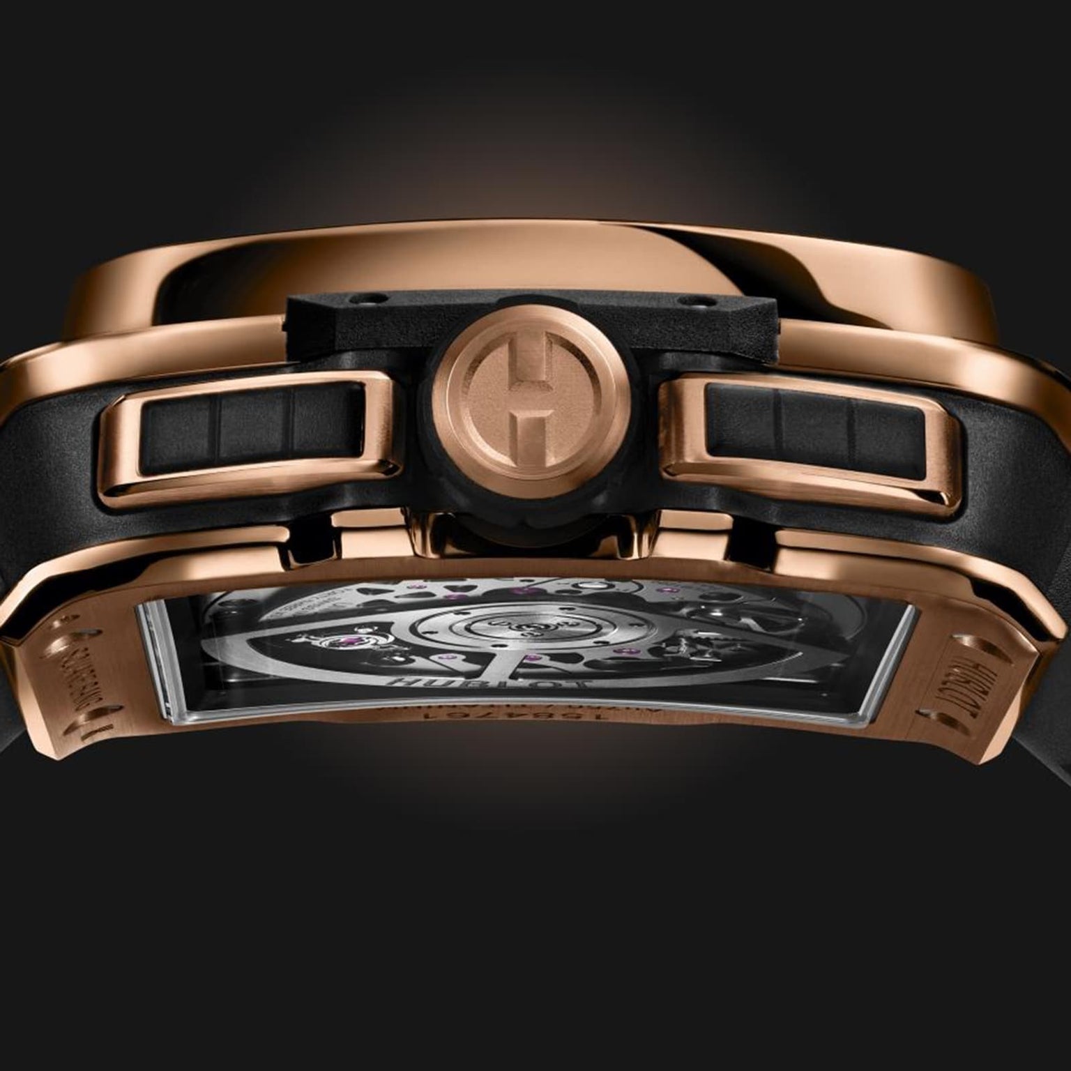 Close-up of the side and back of the Hublot Square Bang Unico King Gold wristwatch, featuring an 18K King Gold case, black buttons, and a visible internal Unico 2 calibre movement.