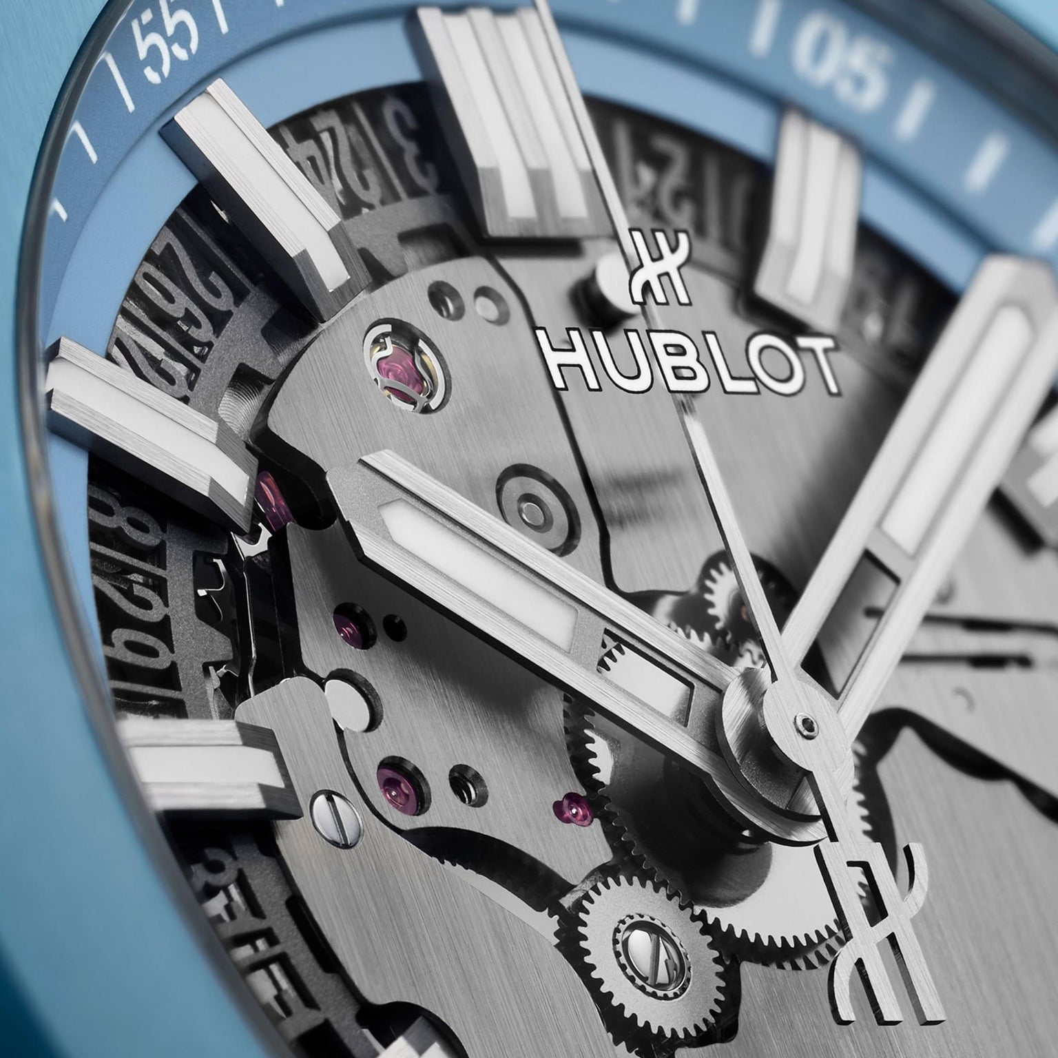 Close-up view of the Hublot Big Bang Integrated Time Only Sky Blue Ceramic watch, showcasing a partially skeletonized dial with luminous blue and silver hour and minute hands, sky blue ceramic accents, and the automatic HUB1710 calibre.