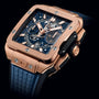 A close-up of Hublots Square Bang Unico King Gold Blue, featuring an 18k King Gold square case, exposed mechanical dial with blue accents, and a textured blue rubber strap.