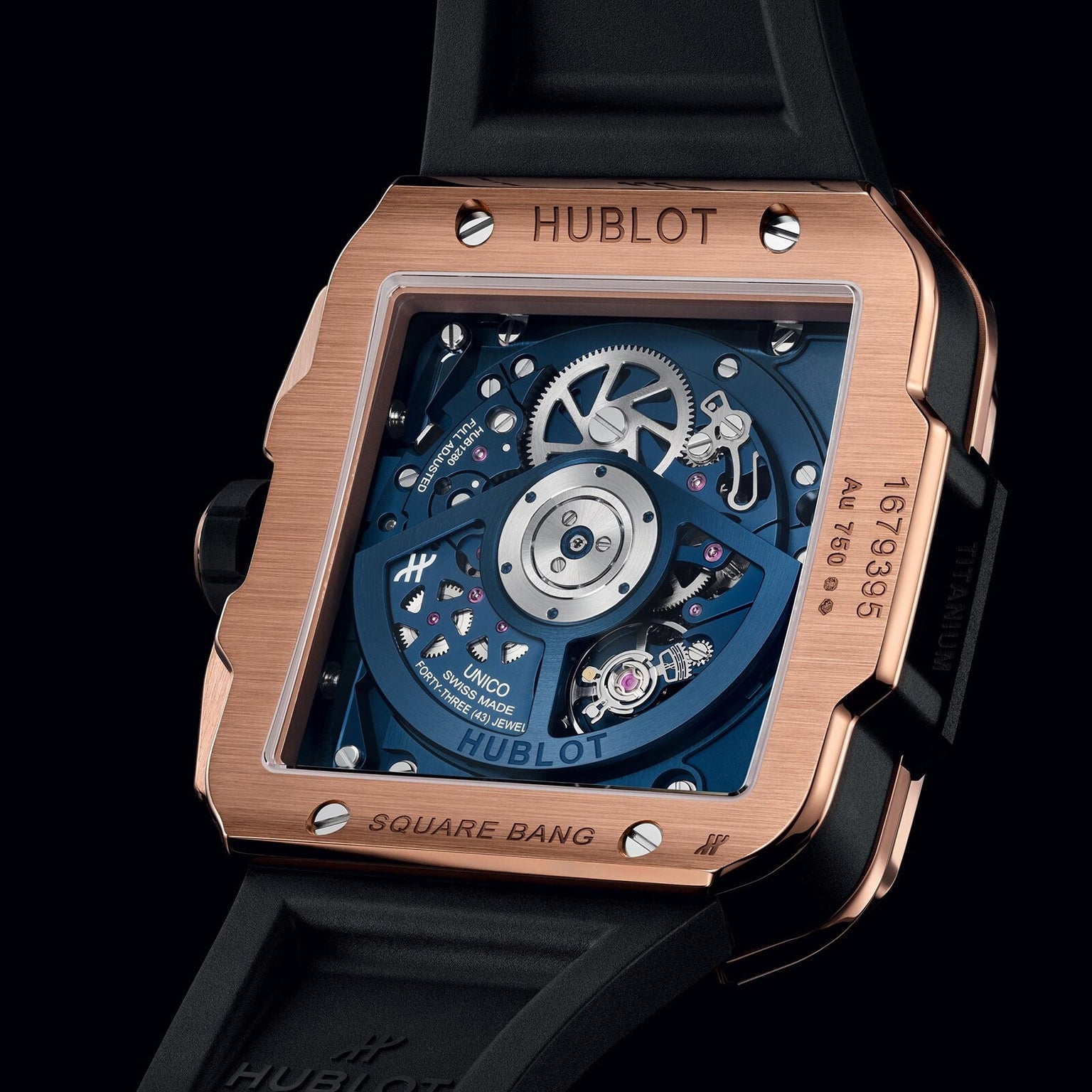 A close-up of the Hublot Square Bang Unico King Gold Blue watch displays its exposed mechanical movement through a transparent case back, highlighting its 18k King Gold craftsmanship.