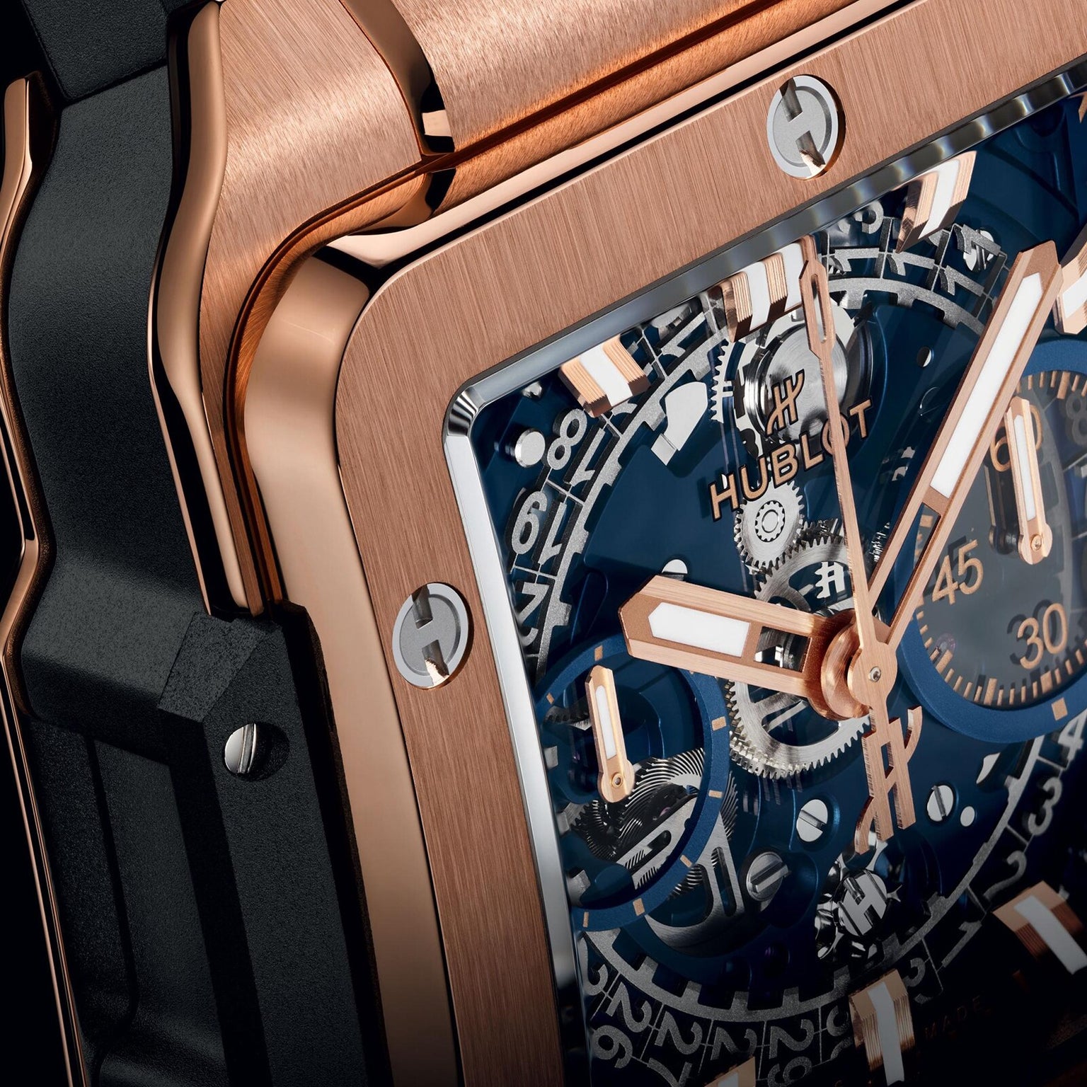 Close-up of Hublots Square Bang Unico King Gold Blue, showcasing its 18k King Gold case, blue dial, and exposed gears that highlight the timepiece’s intricate craftsmanship and mechanical details.