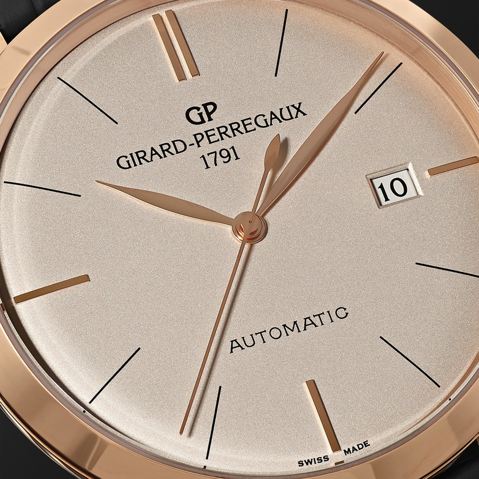 Close-up of the Girard-Perregaux 1966 40 wristwatch face with gold hands, stick indices, date window at 3 o’clock, “AUTOMATIC” and “SWISS MADE” text, all in a pink gold case—a timeless icon of horology.