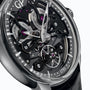 Close-up of the Girard-Perregaux Neo Bridges watch, showcasing its skeleton design with black bridges, visible gears, purple jewels, automatic movement, and a sleek black leather strap.