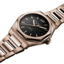 The Laureato 42 by Girard-Perregaux is a pink gold wristwatch with an octagonal bezel, black dial with gold hour markers and hands, date window at 3 o’clock, and a metal link bracelet.