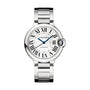 The Ballon Bleu de Cartier wristwatch by Cartier features a round silver face with Roman numerals, blue hands, a metal bracelet, and a blue sapphire cabochon, displayed on a white background.