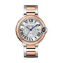 The Ballon Bleu de Cartier is a Cartier wristwatch with a round silver dial, Roman numerals, blue hands, date at 3 o’clock, and a two-tone silver and rose gold metal bracelet.