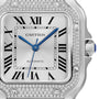 Close-up of the Cartier Santos de Cartier watch with a silver face, blue hands, Roman numeral hour markers, diamond-encrusted bezel, and AUTOMATIC above 6 oclock, highlighting its automatic movement.