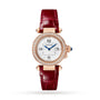 The Pasha de Cartier by Cartier is a womens watch with a round diamond bezel, white dial, blue hands, and a red leather strap in elegant rose gold.