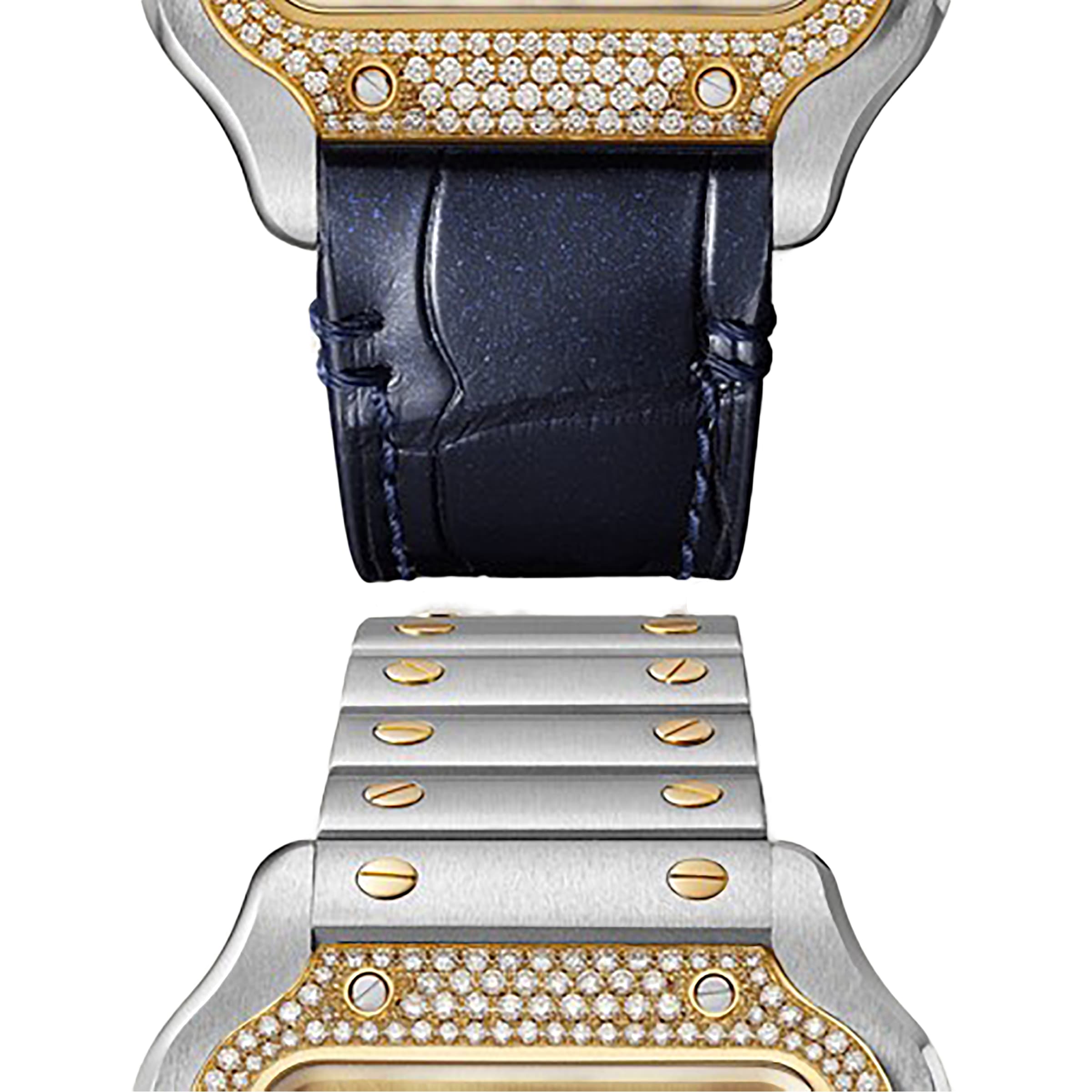 Close-up of the Santos de Cartier Chronograph by Cartier, showcasing a diamond bezel and two interchangeable bands: a dark blue leather strap and a silver metal bracelet with gold accents.