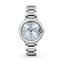 The Ballon Bleu de Cartier by Cartier features a silver round face, Roman numeral markers, blue hands, and an interchangeable steel bracelet, showcased on a white background.