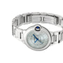 The Ballon Bleu de Cartier by Cartier is shown with a round silver face, Roman numerals, blue hands, and an interchangeable steel bracelet on a white background.