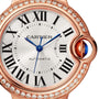 Close-up of the Ballon Bleu de Cartier watch by Cartier, featuring Roman numerals, blue hands, a diamond-set rose gold bezel, and a blue cabochon crown. AUTOMATIC is visible on the dial.