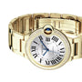 A Cartier Ballon Bleu de Cartier yellow gold wristwatch with a round dial, Roman numerals, diamond bezel, and blue cabochon crown is displayed against a white background.