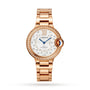 The Ballon Bleu de Cartier by Cartier features a rose gold case, diamond-studded bezel and indices, white patterned dial, blue hands, and a rose gold linked bracelet, shown on a white background.