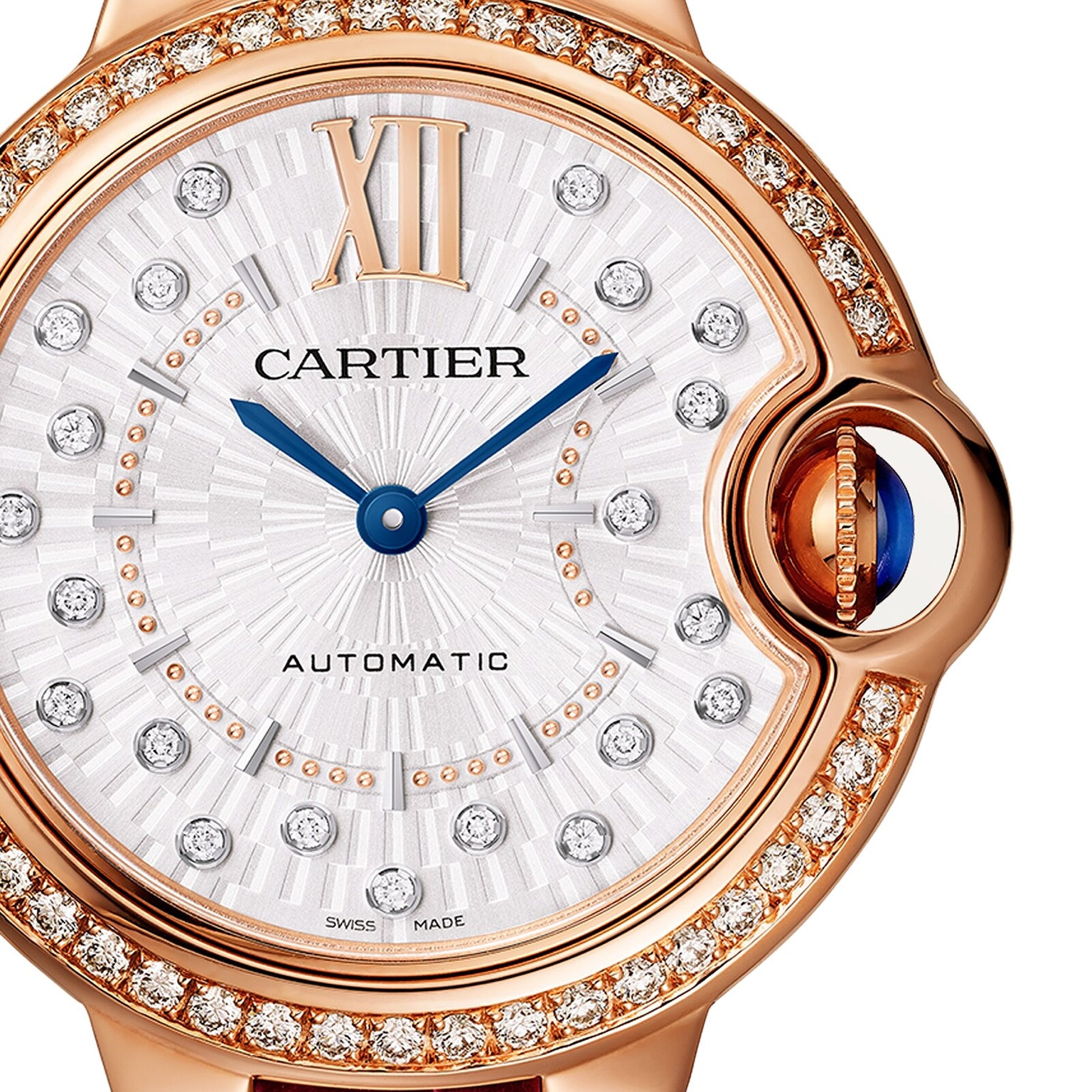 Close-up of the Ballon Bleu de Cartier watch in rose gold by Cartier, showcasing a diamond-studded bezel, Roman numeral XII, blue hands, and AUTOMATIC on its silver dial.