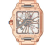 Close-up of a Santos de Cartier Skeleton watch by Cartier in rose gold, featuring an open skeleton dial that reveals detailed inner gears and mechanisms, along with markings for water resistance and gold purity.