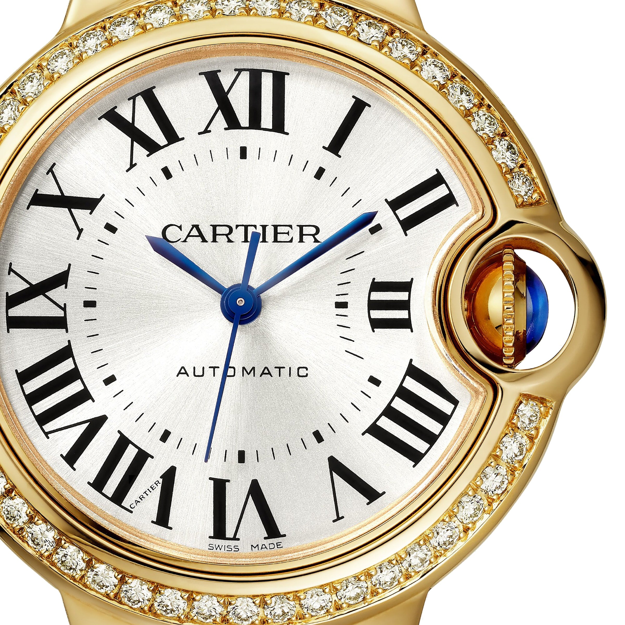Close-up of a Cartier Ballon Bleu de Cartier watch featuring yellow gold, a diamond-set bezel, Roman numeral markers, blue hands, and a crown set with a blue cabochon.